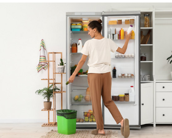 Woman disposing of spoiled food from the fridge.